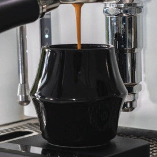 KRUVE CASCADE Porcelain Espresso Glasses (2-Pack) with black double-walled design capturing espresso flow