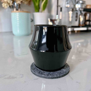 KRUVE CASCADE Porcelain Espresso Glasses (2-Pack) black double-walled cup on felt coaster