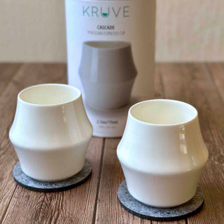 KRUVE CASCADE Porcelain Espresso Glasses (2-Pack) white double-walled cups on stone coasters