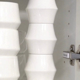 KRUVE CASCADE Porcelain Espresso Glasses (2-Pack) stacked neatly inside white cabinet door open